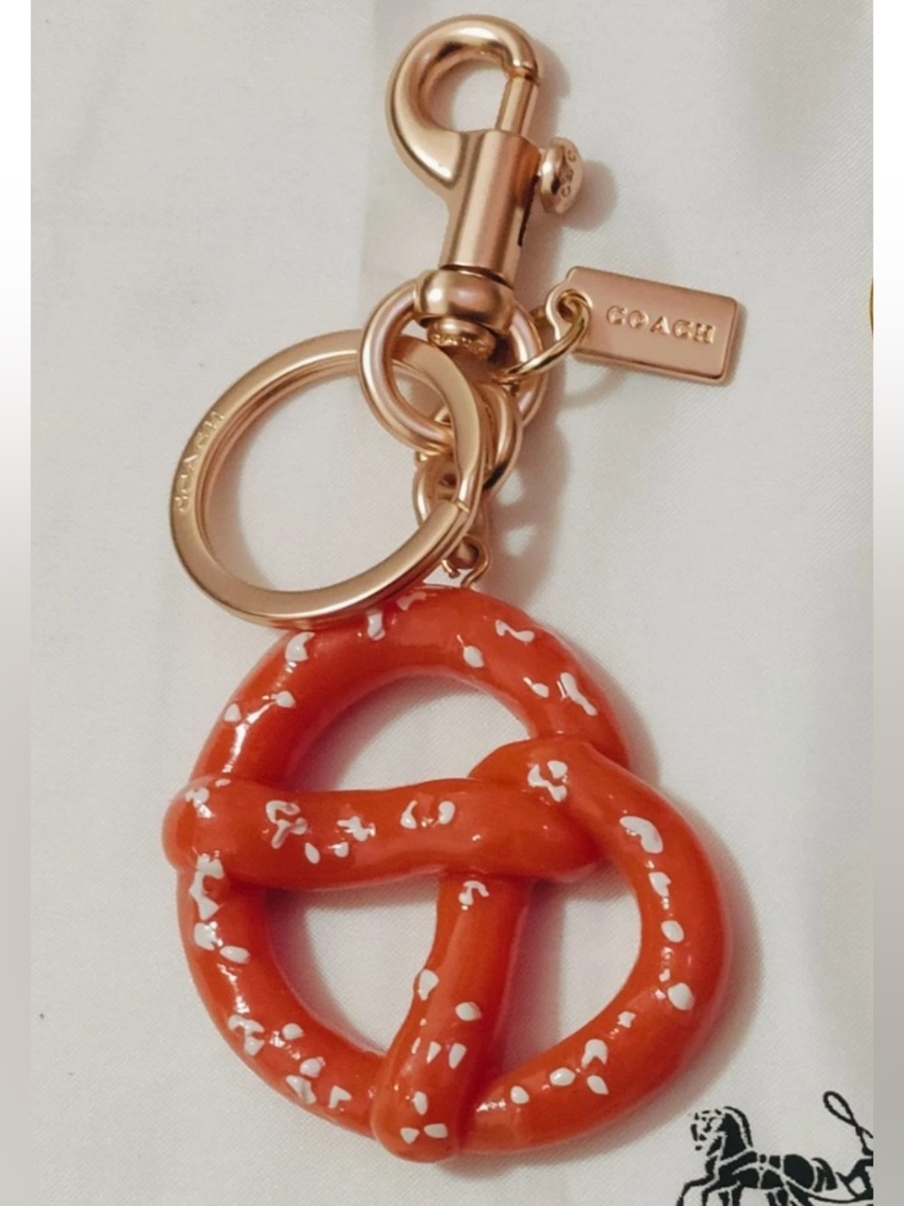 Coach Orange Enamel Pretzel Keychain with Rose Gold Hardware